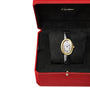 A Cartier Baignoire (Size 15) wristwatch rests on a cushion inside a red and black Cartier box, featuring a gold oval case and black leather strap for timeless elegance.