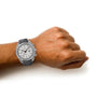 A person’s left wrist wears an OMEGA Speedmaster Dark Side of the Moon Grey Side Edition, featuring a black strap and silver case, with Co-Axial calibre 9300, set against a white background.