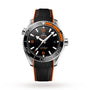 The OMEGA Seamaster Planet Ocean 600M is a black dive watch with a black dial, orange accents, date window, and a black textured strap with orange edges, shown on a white background. This Master Chronometer combines style and precision.