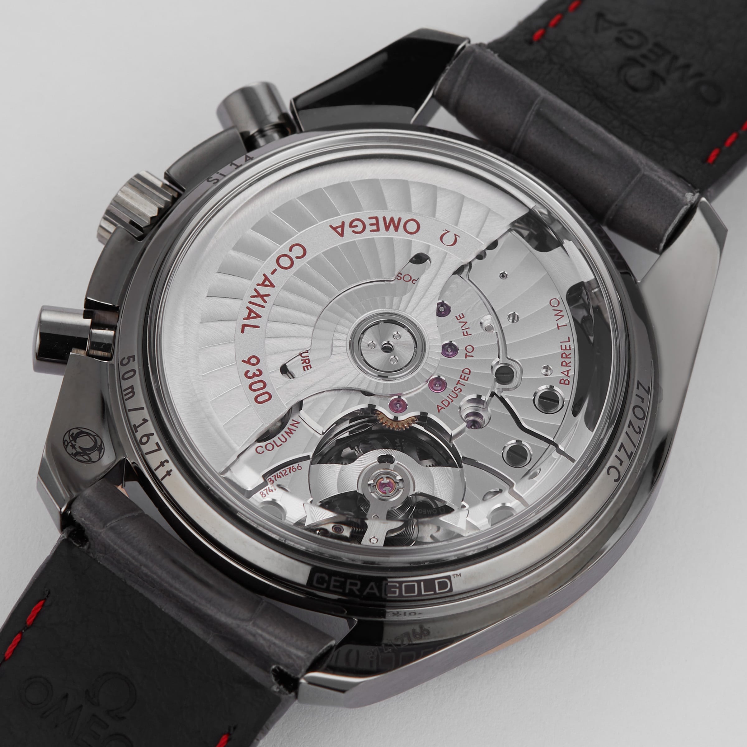 Close-up of the transparent case back on the OMEGA Speedmaster Dark Side of the Moon Meteorite, showcasing its ceramic case and revealing the intricate mechanical movement with engraved details.