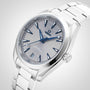 The OMEGA Seamaster Aqua Terra 150M features a striped light gray dial, blue hands and markers, date window at 6 o’clock, stainless steel bracelet, and master chronometer certification inspired by maritime heritage.