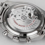 Close-up of the transparent case back of the OMEGA Speedmaster Racing, revealing the Master Chronometer-certified mechanical movement with visible gears and Omega Master Co-Axial 9900 labeling.