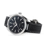 The OMEGA Seamaster Aqua Terra 150M wristwatch features a black dial, silver hour markers, and a black textured strap, displayed at an angle on a white background—evoking the precision of luxury sailboats.