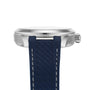 Side view of an OMEGA Seamaster Aqua Terra 150M with a silver case, blue textured strap, and visible crown set against a white background.