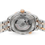 Close-up of the back of an OMEGA Seamaster Diver 300M, highlighting its transparent case with visible movement, engraved details on the metal, and a strap combining silver and rose gold tones.