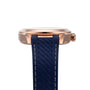 Side view of the OMEGA Seamaster Aqua Terra 150M with a rose gold case, blue textured rubber strap, visible crown, and Master Chronometer 8800 calibre movement set against a white background.