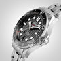 A close-up of the OMEGA Seamaster Diver 300M shows its stainless steel case, black wave-pattern dial, bold white markers, and metal bracelet.