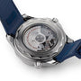 Close-up of the back of an OMEGA Seamaster Diver 300M wristwatch with a transparent case revealing its movement and engraved text, attached to a blue strap.