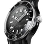 Close-up of an OMEGA Seamaster Diver 300M watch with a black ceramic bezel, black wave-patterned dial, and rubber strap, displaying the time at about 10:08.
