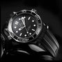 A close-up of the OMEGA Seamaster Diver 300M wristwatch featuring a black rubber strap, white hour markers, and a unidirectional rotating bezel.