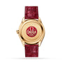 The back of an OMEGA De Ville Trésor wristwatch with a gold case and red leather strap features a 125th Anniversary Edition engraving in red and gold, and houses the Master Chronometer Calibre 8910.