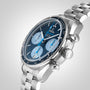A close-up of the OMEGA Speedmaster 38 Orbis Edition in stainless steel, featuring a blue dial with three subdials and a tachymeter bezel, shown on a metal link bracelet.