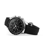 An OMEGA Speedmaster Moonwatch Professional wristwatch with a chronograph dial, black fabric strap, and 3861 calibre movement is shown on a white background.