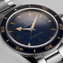 Close-up of the OMEGA Seamaster 300 dive watch with a blue dial, vintage yellow markers, and a stainless steel case and bracelet, featuring Co-Axial Master Chronometer precision.