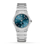 The OMEGA Constellation is a 34mm stainless steel watch featuring a blue dial, diamond hour markers, Roman numerals on the bezel, and a date display at 6 o’clock.