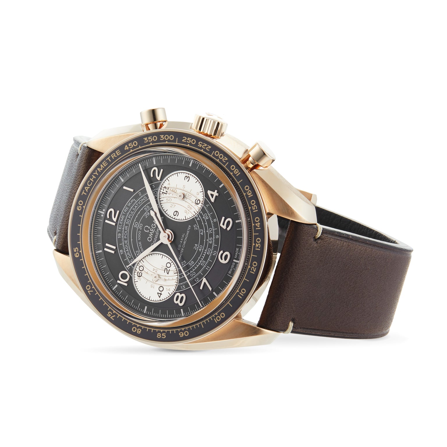 The OMEGA Speedmaster Chronoscope features a black dial, gold case, two subdials, tachymeter scale, and brown leather strap for a vintage-inspired look against a white background.
