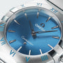 Close-up of the OMEGA Constellation watch with a celestial blue dial, silver hands, and Roman numerals on a brushed stainless steel bezel.