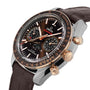 The OMEGA Speedmaster Moonwatch Co-Axial Chronograph features a 42.5 mm stainless steel and 18K Sedna™ gold case, brown leather strap, black and gold bezel, subdials, date display, and a realistic moonphase indicator, shown angled.