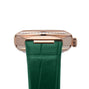 A close-up of the OMEGA Constellation shows its watch case adorned with a row of diamonds, Sedna™ gold accents, and a green leather strap.