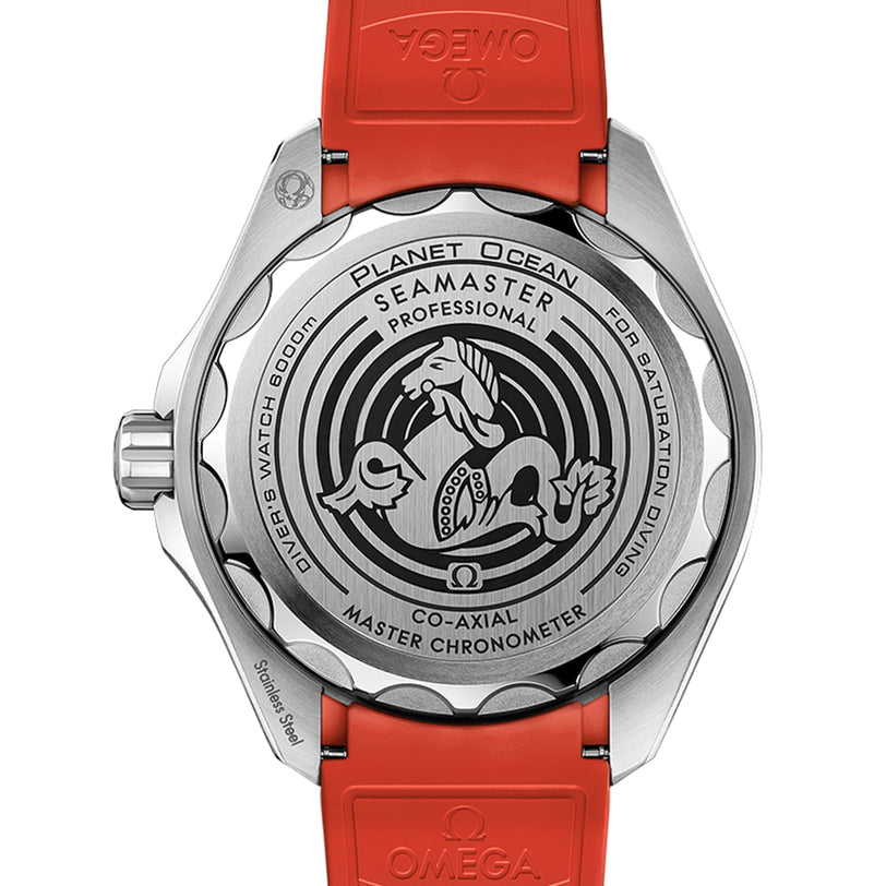 Back view of the OMEGA Seamaster Planet Ocean 6000M, featuring a red strap and engraved graphics highlighting its model and O-MEGASTEEL specs, crafted for saturation divers.
