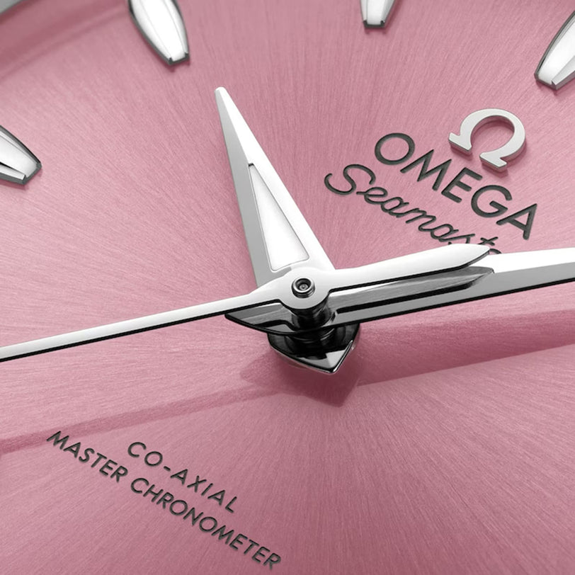Close-up of an OMEGA Seamaster Aqua Terra 150M with a pink dial, silver hands and indices, featuring Co-Axial Master Chronometer text and powered by the 8800 calibre movement.