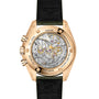 Back view of the OMEGA Speedmaster Moonwatch Professional, with a transparent case back revealing the mechanical movement and engraved details, shown on a black leather strap.
