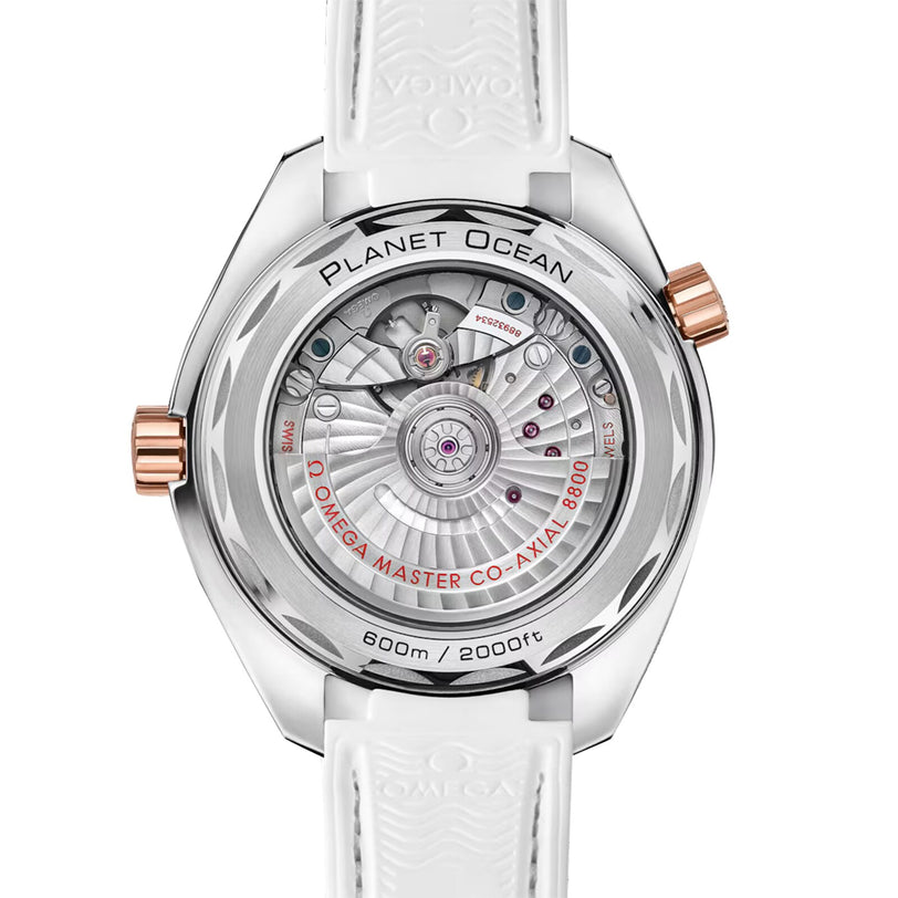 Back view of the OMEGA Seamaster Planet Ocean 600M watch, featuring an exposed Master Chronometer Co-Axial 8800 movement, white strap, and rose gold crown and accents.