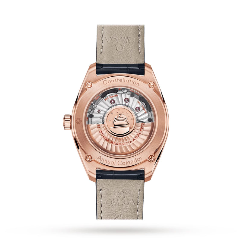The OMEGA Constellation Globemaster showcases its movement through a transparent case back with engraved details, features an elegant leather strap, and is enhanced by accents of 18K Sedna™ gold.