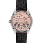 The image shows the back of the OMEGA De Ville Tourbillon featuring an exposed rose-gold mechanical movement with decorative jewels and a black leather strap embossed with the OMEGA logo.