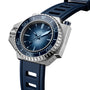 An OMEGA Seamaster Ploprof 1200M Summer Blue dive watch with a blue dial, blue bezel, blue rubber strap, and prominent crown guard is displayed at an angle.