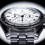 Close-up of the OMEGA Speedmaster Moonwatch Professional, showcasing a white dial, black bezel, three subdials, stainless steel bracelet, and powered by the precise Omega 3861 calibre.