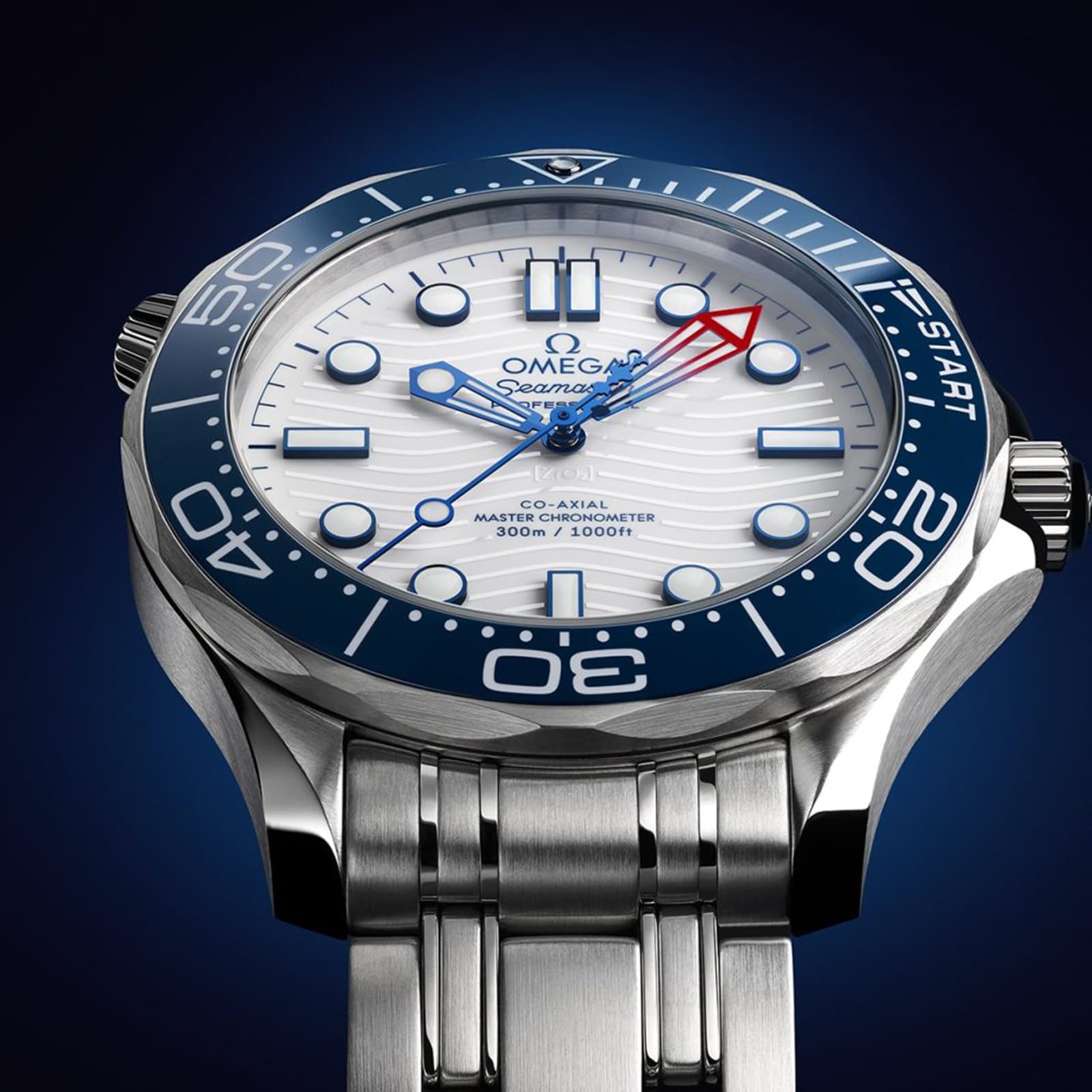 Close-up of the OMEGA Seamaster Diver Americas Cup 300M, showcasing a white textured dial, blue regatta bezel, and red-tipped second hand. Powered by the Co-Axial Master Chronometer Calibre 8806, set against a dark blue backdrop.