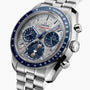 A close-up of the OMEGA Speedmaster Moonphase Meteorite watch featuring a silver and blue face, multiple subdials, OMEGA Co-Axial Master Chronometer movement, and a stainless steel bracelet.