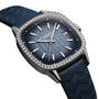 The Raymond Weil Freelancer Automatic 60 Diamonds Blue Dial features a blue textured dial, diamond-studded bezel, date at 3 oclock, and a wavy-pattern blue leather strap.