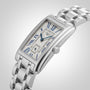 The Longines DolceVita showcases a rectangular stainless steel case, metal link bracelet, blue Roman numerals and hands, and a date window on its white dial—an elegant timepiece from the renowned brand.