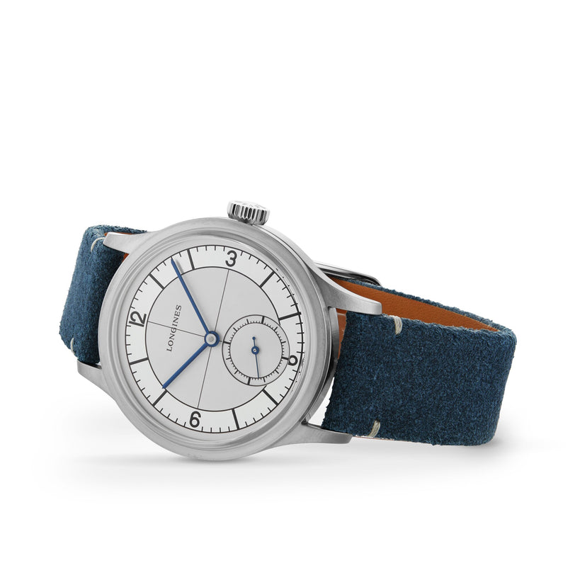 The Longines Sector Dial silver wristwatch features a stainless steel case, white dial, blue hands, small seconds subdial, and a blue suede strap, displayed against a white background.