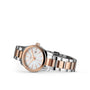 A Longines Conquest Classic wristwatch with a white dial, date display, and a stainless steel and PVD bracelet is shown angled on a white background.
