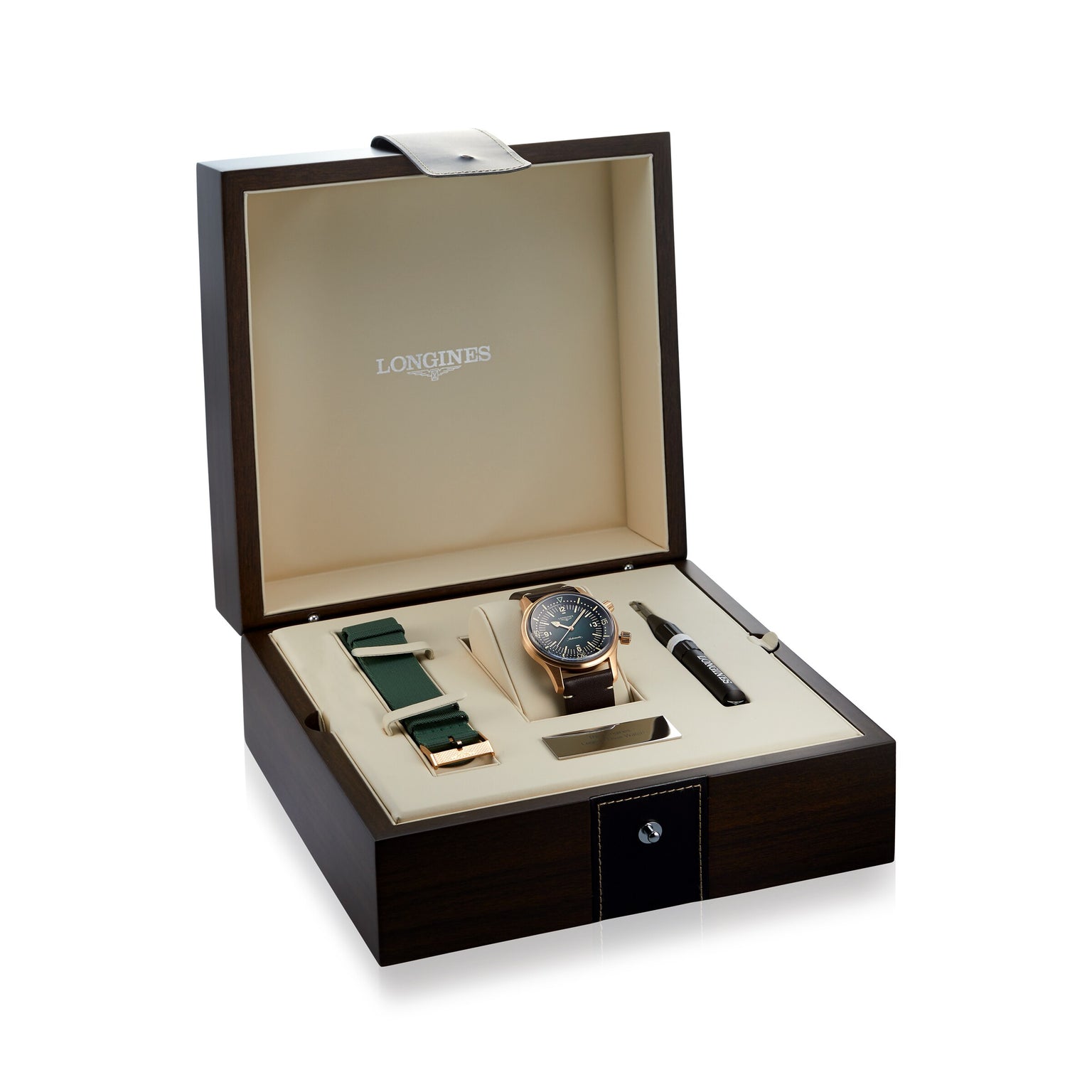 The Longines Legend Diver Bronze watch set features a bronze case, extra green strap, tool, and buckle, all presented in a wooden case with a cream interior.