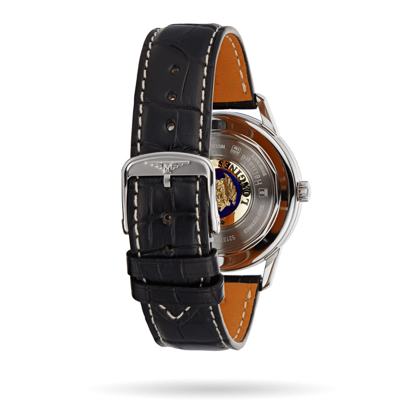 The Longines Flagship Heritage wristwatch features a black leather strap with a metal buckle, an engraved back case displaying a gold lion emblem, and refined details inspired by Swiss Super-LumiNova craftsmanship.