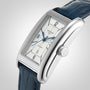The Longines DolceVita features a rectangular stainless steel case, white dial with blue hands, Arabic numerals, date at 6 o’clock, and a blue leather strap.