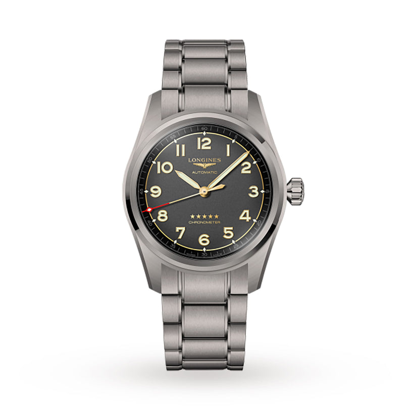 The Longines Spirit is a stainless steel wristwatch with a black dial, luminous numerals, and yellow accents on a metal link bracelet, inspired by the brand’s aviation collection and shown against a white background.
