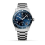 The Longines Spirit Zulu Time wristwatch features a stainless steel case, blue dial with silver Super-LumiNova markers, date at 6 o’clock, and a metal bracelet, displayed on a white background.