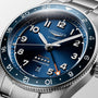 Close-up of a Longines Spirit Zulu Time automatic watch featuring a blue dial, Swiss Super-LumiNova silver markers, date window, orange-tipped GMT hand, and stainless steel bracelet.