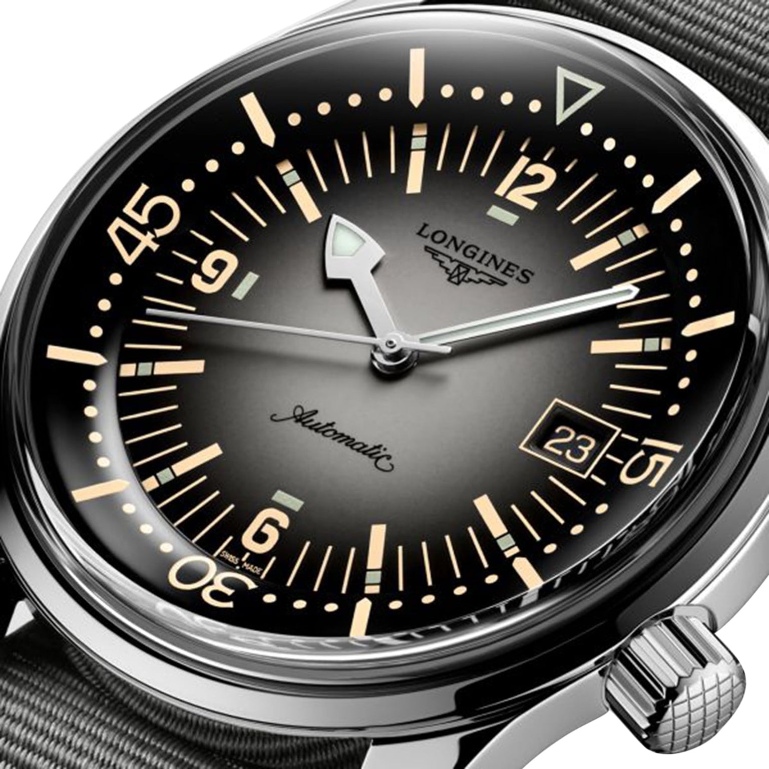Close-up of the Longines Legend Diver watch with a black dial, bold hour markers, luminous hands, date display, L888 movement, and a grey textile strap.