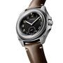 A Longines Pilot Majetek wristwatch featuring a silver case, black dial, brown leather strap, and vintage-style numerals.