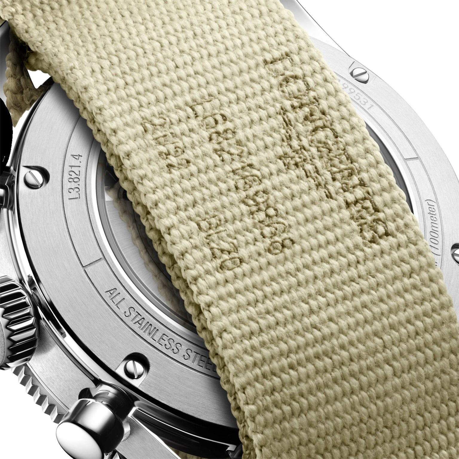 Close-up of the back of the Longines Spirit Flyback wristwatch, showcasing its chronometer status, with a beige woven fabric strap partially covering the engraved case back.