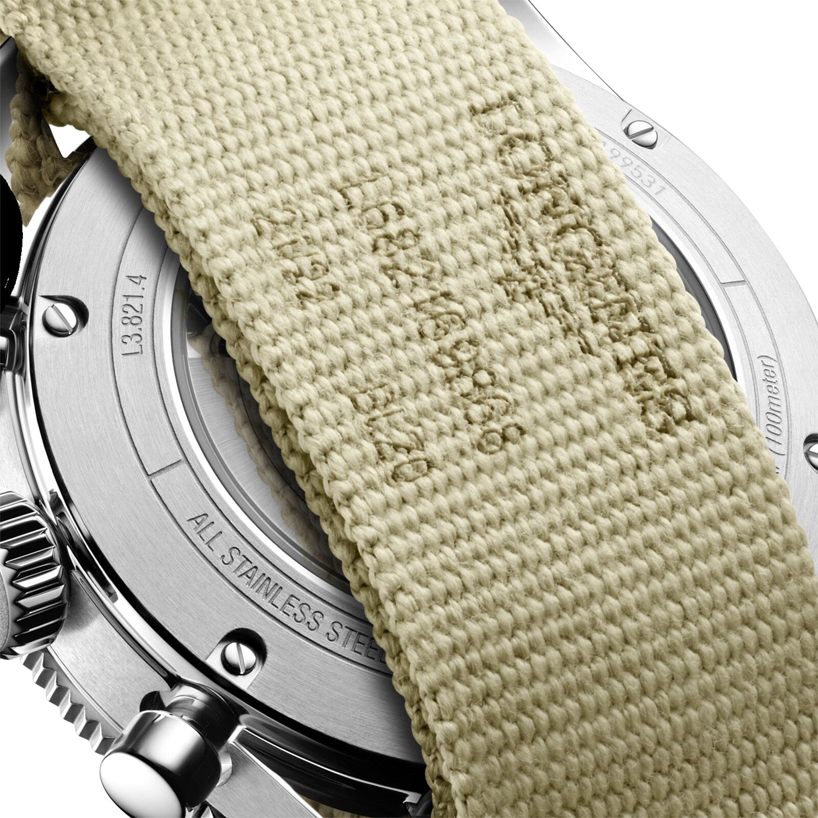 Close-up of the back of the Longines Spirit Flyback wristwatch, showcasing its chronometer status, with a beige woven fabric strap partially covering the engraved case back.