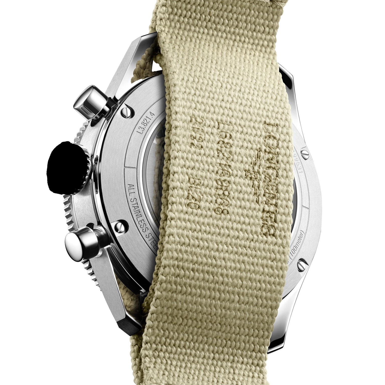 The Longines Spirit Flyback features a stainless steel case back, partially covered by a beige fabric strap.