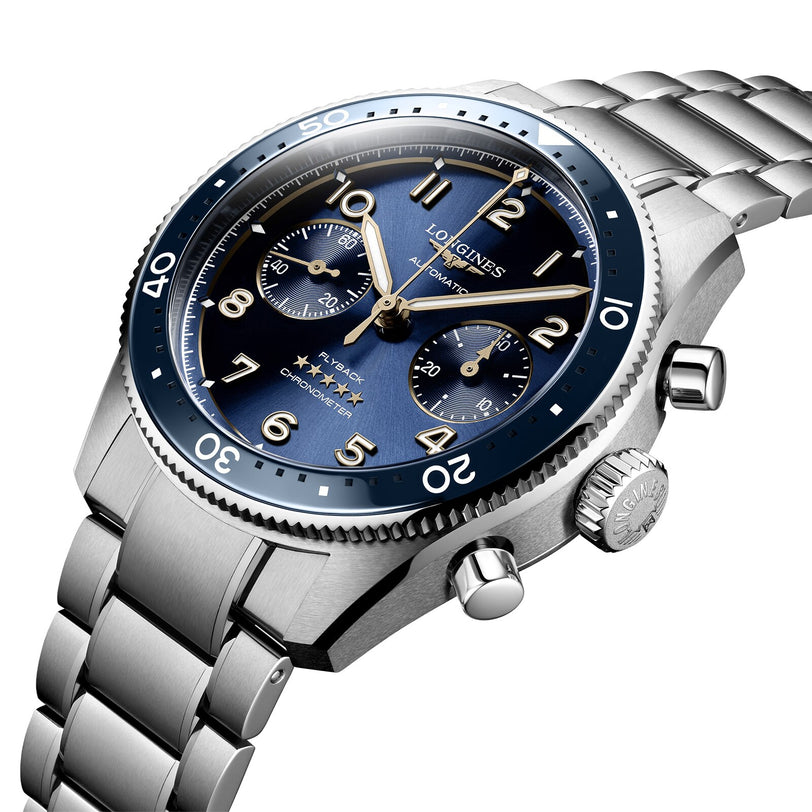 The Longines Spirit Flyback features a stainless steel case, blue sunray dial with three subdials, automatic L791 movement, rotating bezel, and metal link bracelet, presented at an angle.