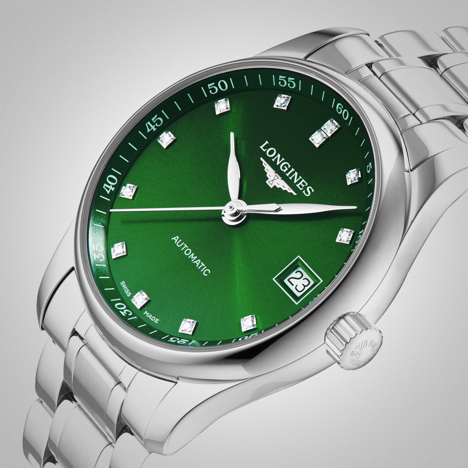 A Longines Master Collection silver wristwatch with a green dial, diamond indexes, date window at 3 o’clock, and Longines Automatic branding.